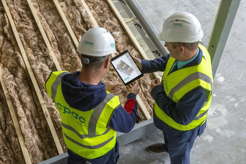 Two workers reviewing an inspection tablet together