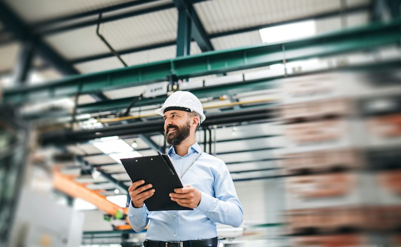 Engineer with clipboard on the factory floor